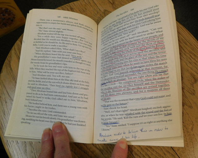 The book is open and the text is heavily underlined. Comments have been added in the margin. 